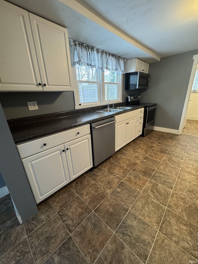 kitchen with sink, white cabinets, and appliances with stainless steel finishes