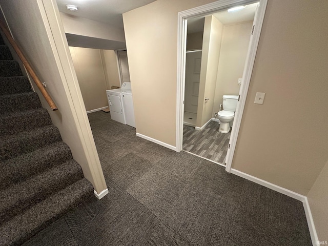 hall featuring dark colored carpet and separate washer and dryer