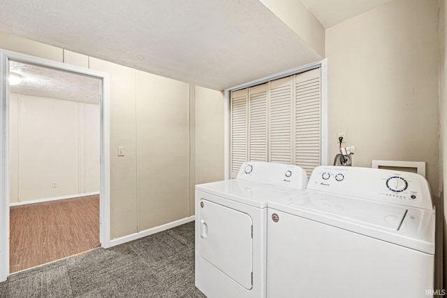 clothes washing area featuring washer and clothes dryer and dark colored carpet