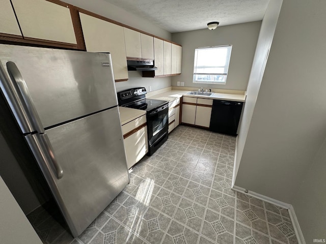 kitchen featuring a textured ceiling, sink, white cabinetry, and black appliances