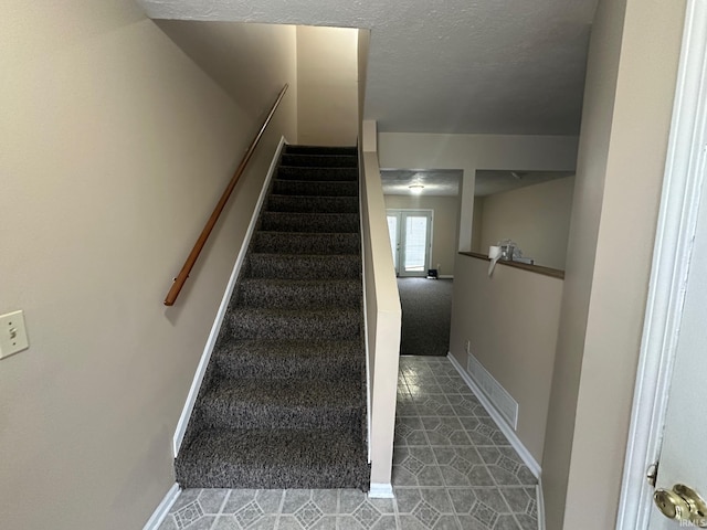 stairway featuring french doors