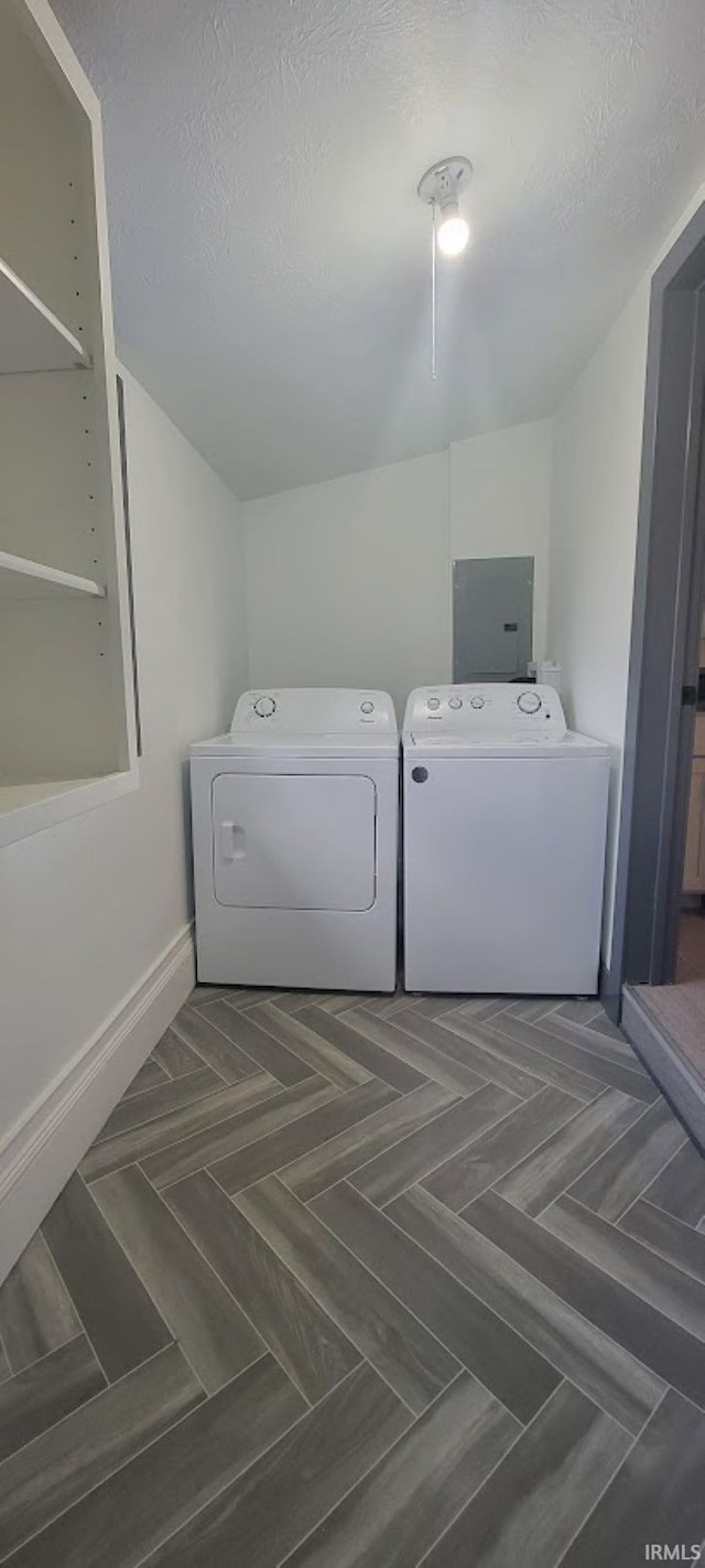 laundry area featuring washer and clothes dryer and a textured ceiling