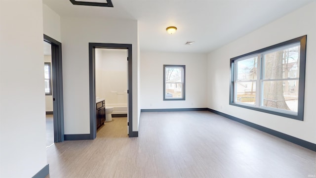 interior space with a wealth of natural light and light hardwood / wood-style flooring