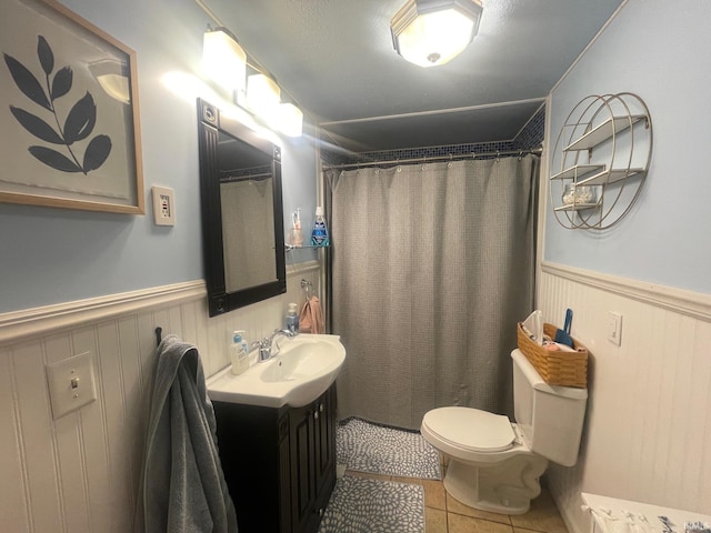 bathroom featuring a shower with curtain, tile patterned flooring, vanity, and toilet