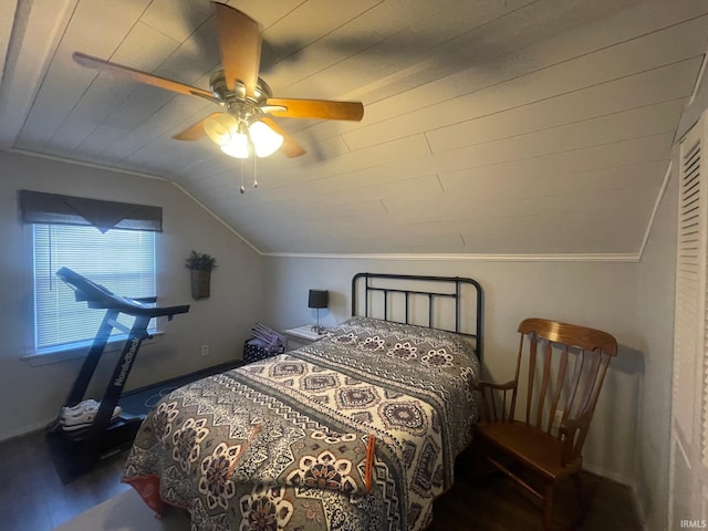 bedroom with hardwood / wood-style floors, ceiling fan, ornamental molding, and vaulted ceiling