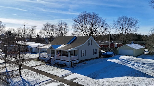 view of front of home with an outbuilding, covered porch, and a garage