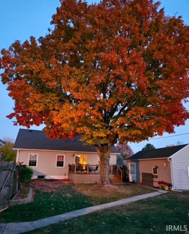 exterior space featuring a lawn and a deck