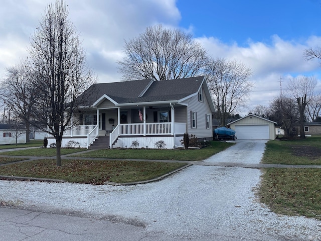 view of front facade with a porch, an outbuilding, a front yard, and a garage