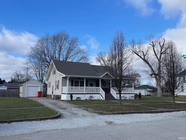 view of front of house featuring a front yard, covered porch, an outdoor structure, and a garage