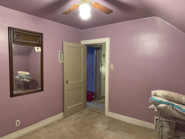 unfurnished bedroom featuring ceiling fan, light colored carpet, and lofted ceiling