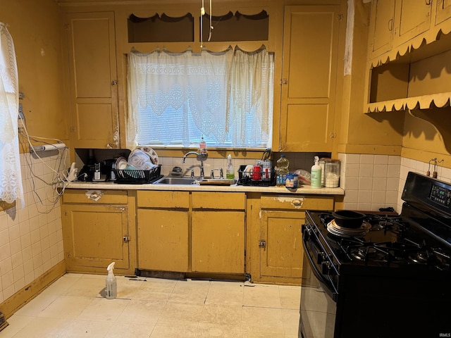 kitchen with black gas range and sink