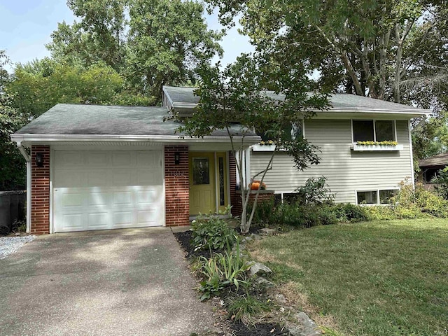 tri-level home featuring a front yard and a garage