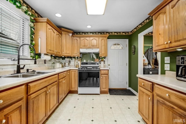 kitchen with white range oven and sink