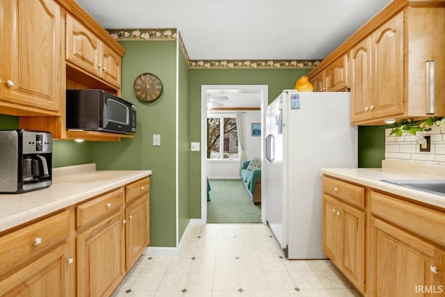 kitchen with decorative backsplash, white refrigerator, and ceiling fan