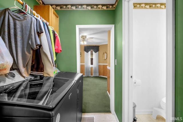 laundry room with ceiling fan, light tile patterned flooring, ornamental molding, and washing machine and clothes dryer