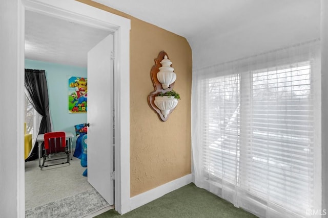 interior space with carpet floors and lofted ceiling