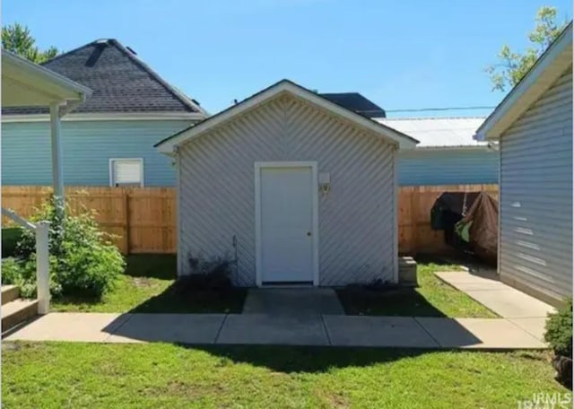 view of outbuilding with a yard