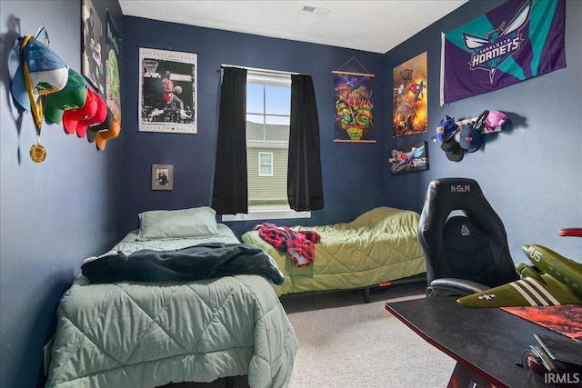 bedroom with carpet and a textured ceiling