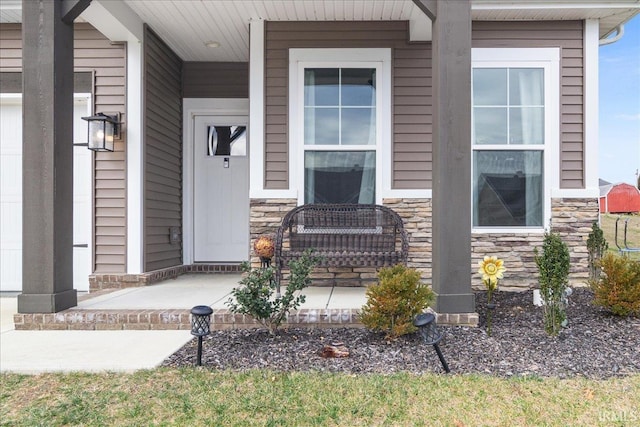 view of exterior entry featuring covered porch