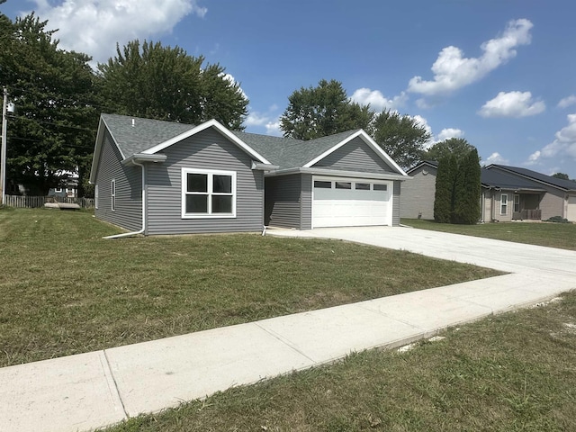 view of front of property featuring a front yard and a garage