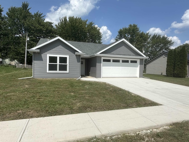 single story home featuring a garage and a front lawn