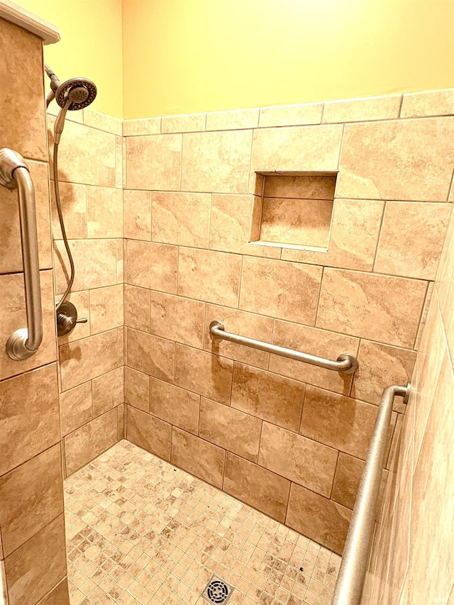 bathroom with tiled shower