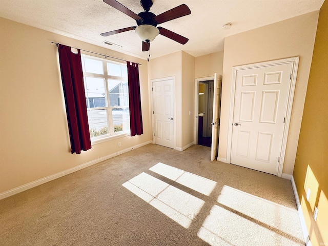 unfurnished bedroom with light colored carpet and ceiling fan