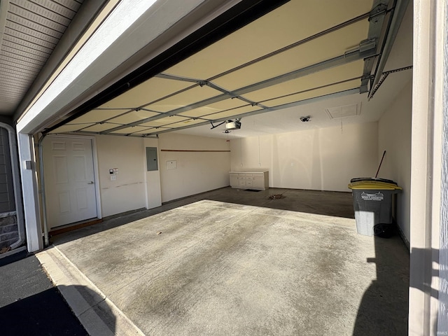 garage with electric panel and a garage door opener