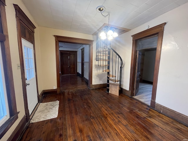 hall featuring dark hardwood / wood-style flooring and an inviting chandelier