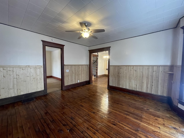 empty room with ceiling fan and dark wood-type flooring