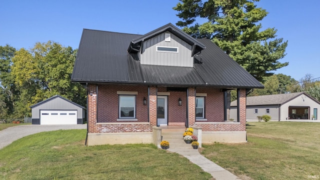 view of front of house with a garage, a front lawn, and an outdoor structure