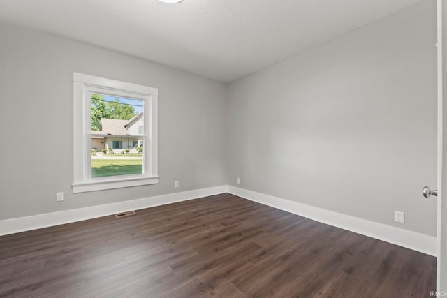 unfurnished room featuring dark hardwood / wood-style flooring