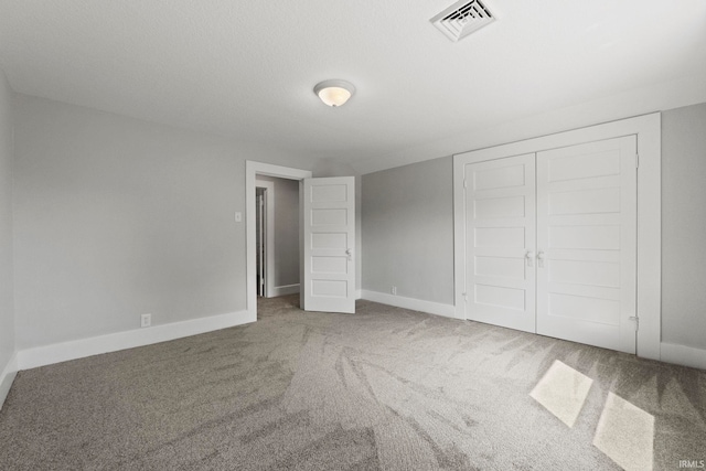 unfurnished bedroom with carpet and a closet