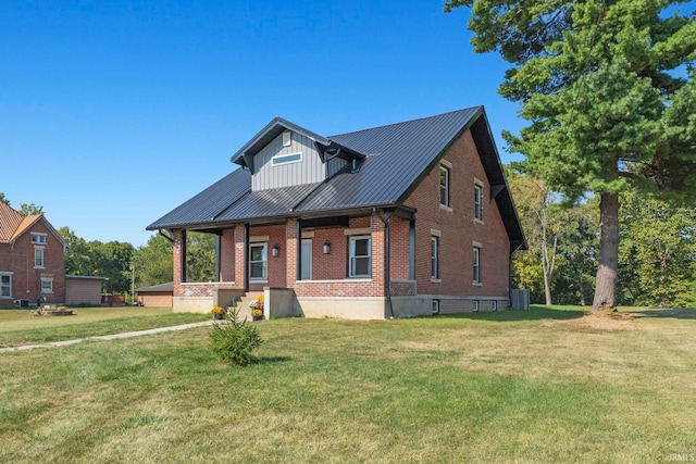 view of front of home with a porch, cooling unit, and a front lawn