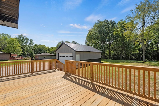 wooden terrace featuring a yard, an outdoor structure, and a garage