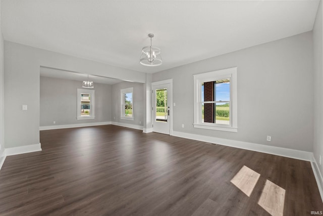 interior space featuring a notable chandelier and dark hardwood / wood-style flooring