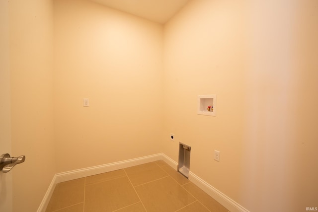 clothes washing area featuring hookup for an electric dryer, hookup for a washing machine, and tile patterned flooring