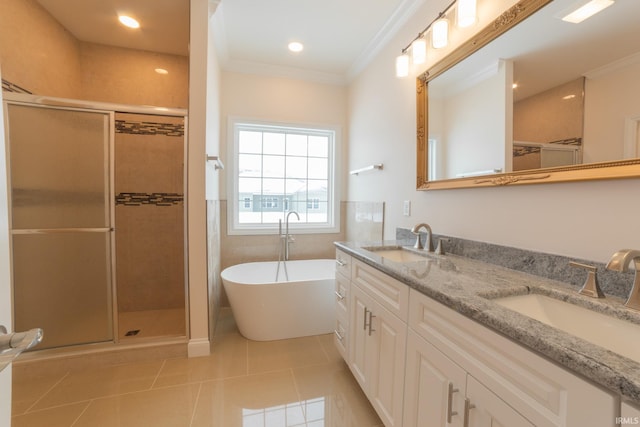 bathroom featuring tile patterned flooring, vanity, ornamental molding, and plus walk in shower