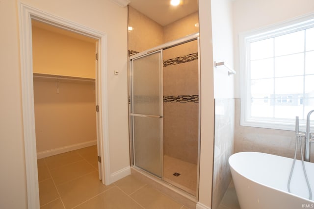 bathroom featuring tile patterned floors and independent shower and bath