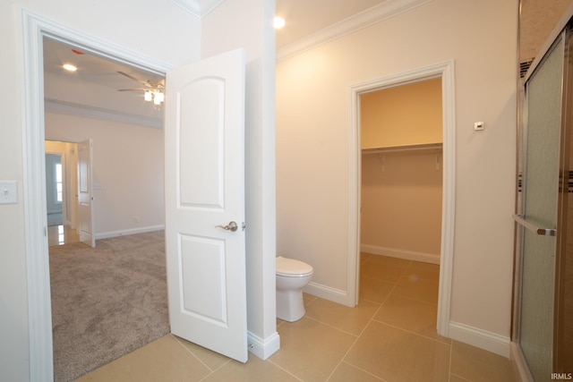 bathroom featuring tile patterned floors, ceiling fan, walk in shower, and ornamental molding