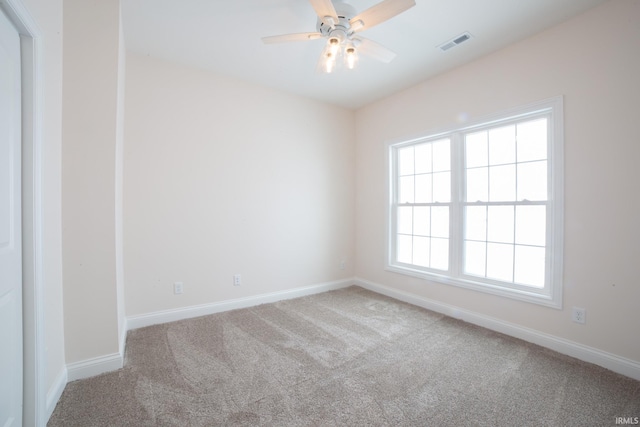 carpeted empty room featuring ceiling fan