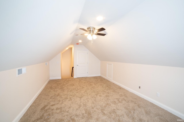 additional living space with ceiling fan, light carpet, and lofted ceiling