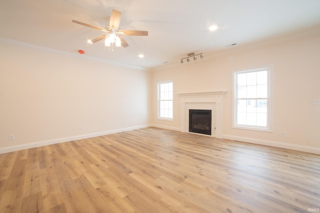 unfurnished living room with rail lighting, ceiling fan, crown molding, and light hardwood / wood-style flooring