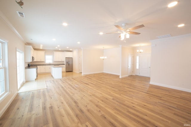 unfurnished living room featuring crown molding, light hardwood / wood-style flooring, and ceiling fan with notable chandelier