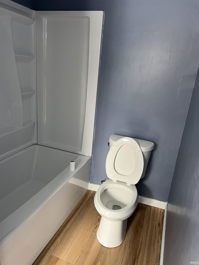 bathroom with hardwood / wood-style floors and toilet