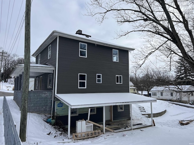 view of snow covered house