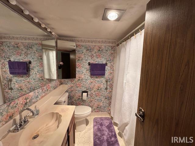 bathroom featuring vanity and toilet