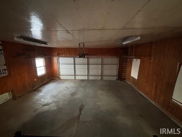 garage featuring wooden walls and a garage door opener