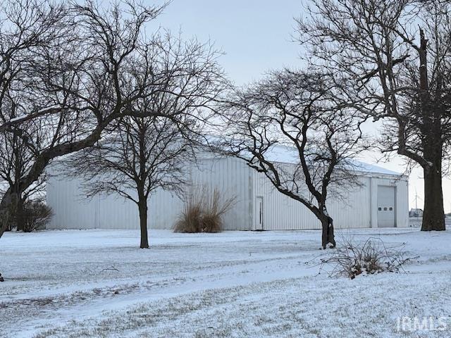 yard covered in snow with an outdoor structure