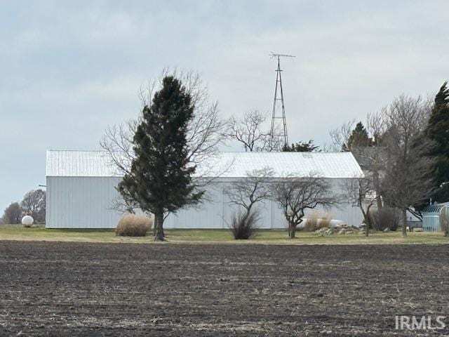 view of home's exterior featuring an outbuilding and a pole building